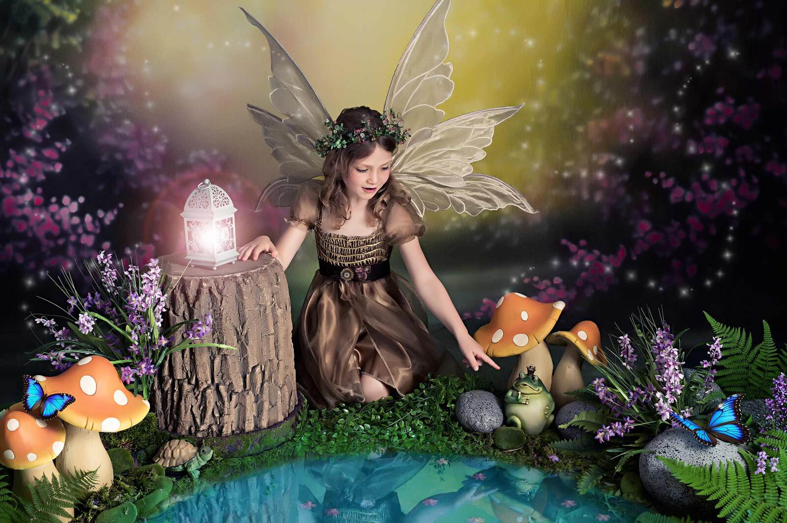 Girl dressed as a fairy looking at her reflection in a pond beside a tree stump with orange mushrooms and blue butterflies in a forest setting